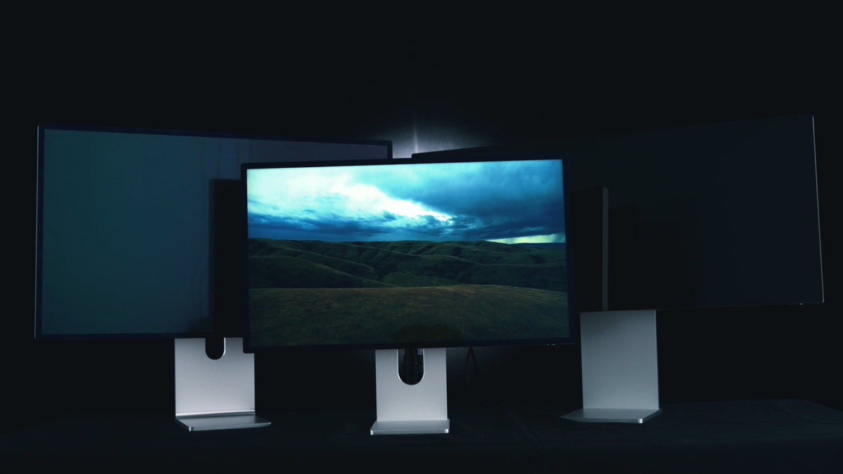 KUYCON aluminum monitors displaying a dramatic landscape