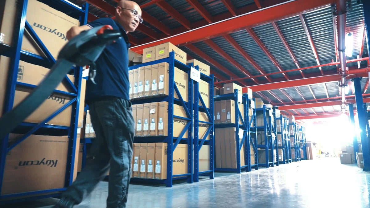 Warehouse staff moving stock with a pallet truck